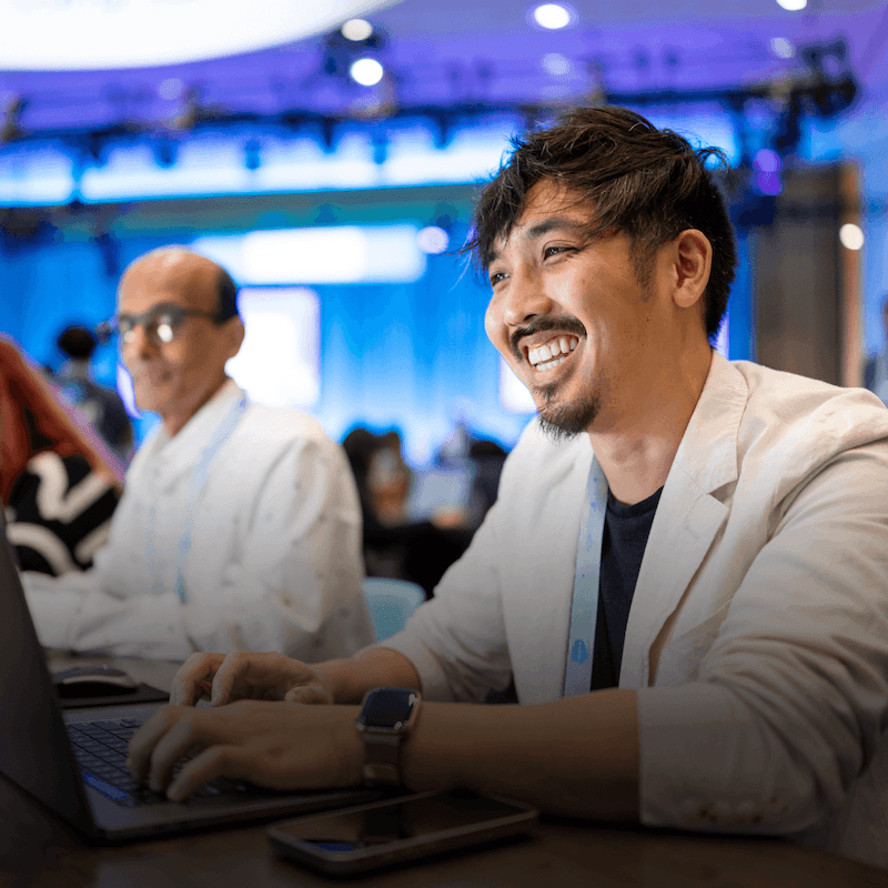Tailblazers working on laptops at an event